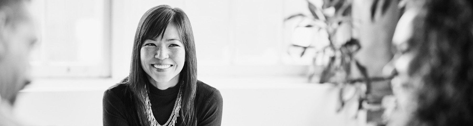Image of smiling businesswoman at meeting
